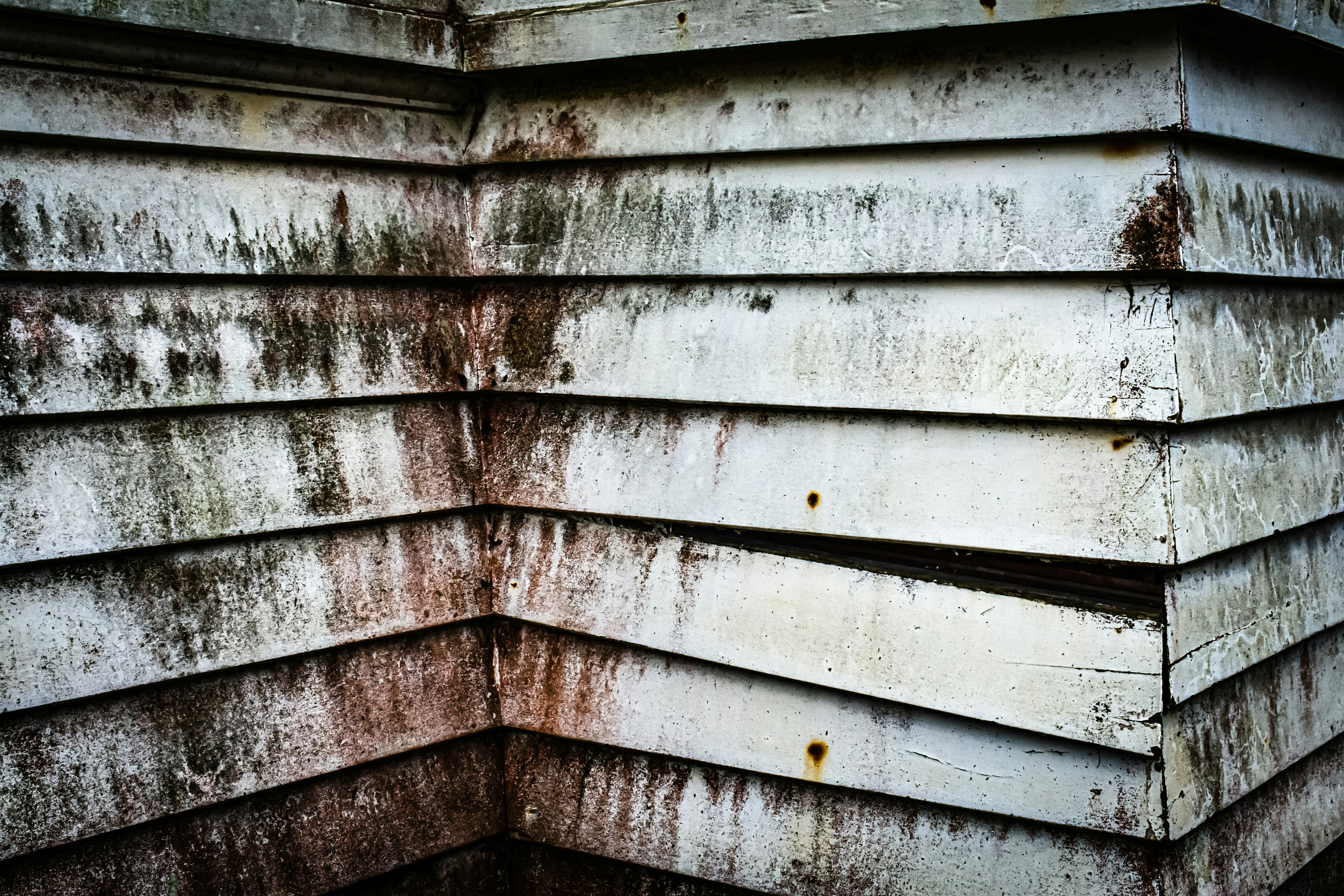 Weathered wooden siding with streaks of dirt.