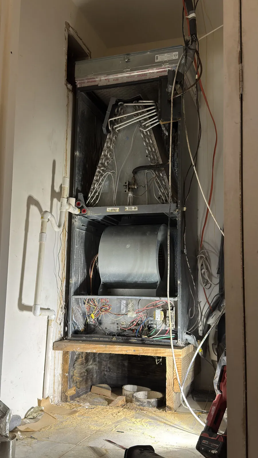 Air handler in a hallway closet, panels off for inspection