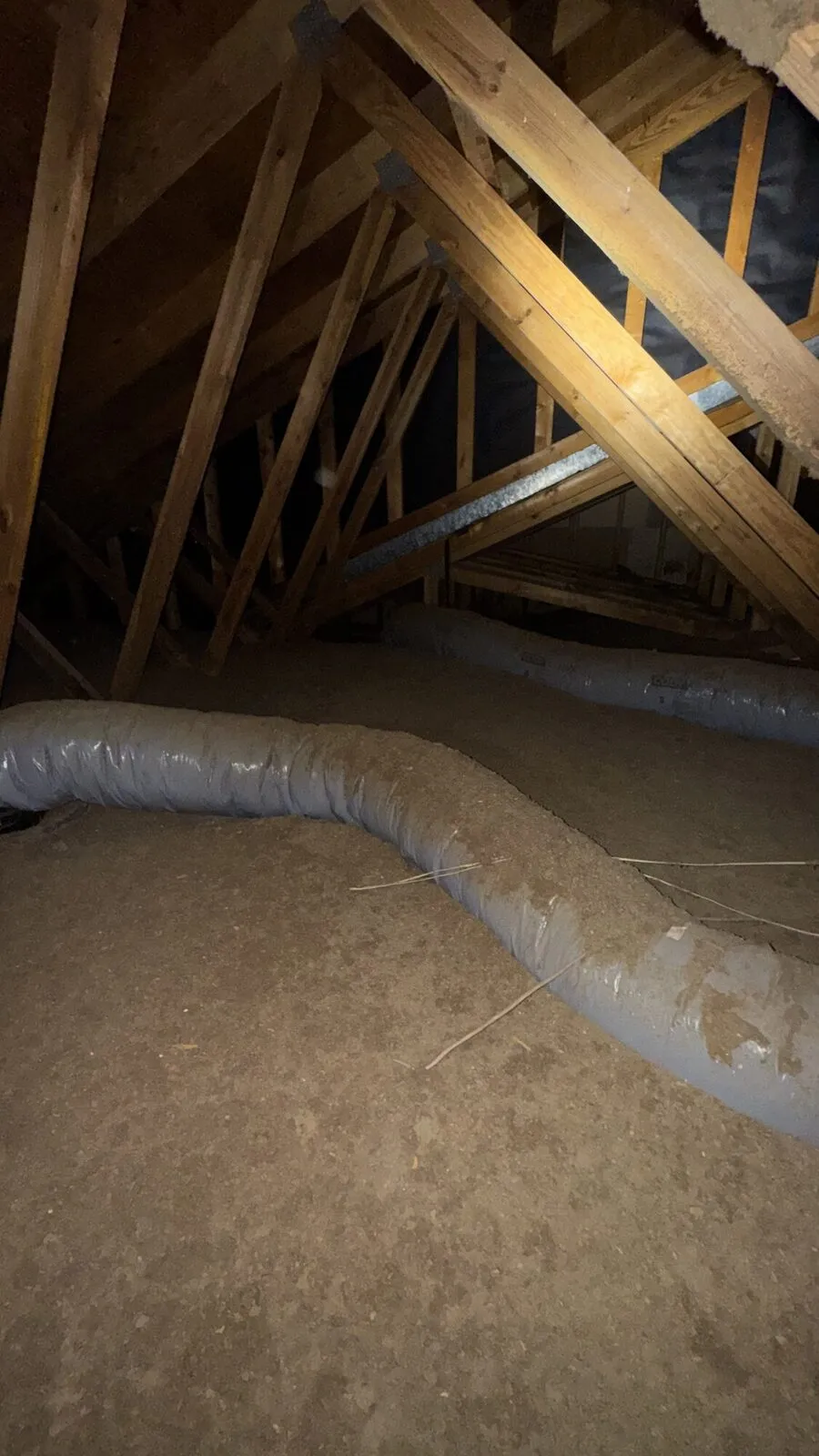 Thin, settled insulation with bare decking showing between the joists