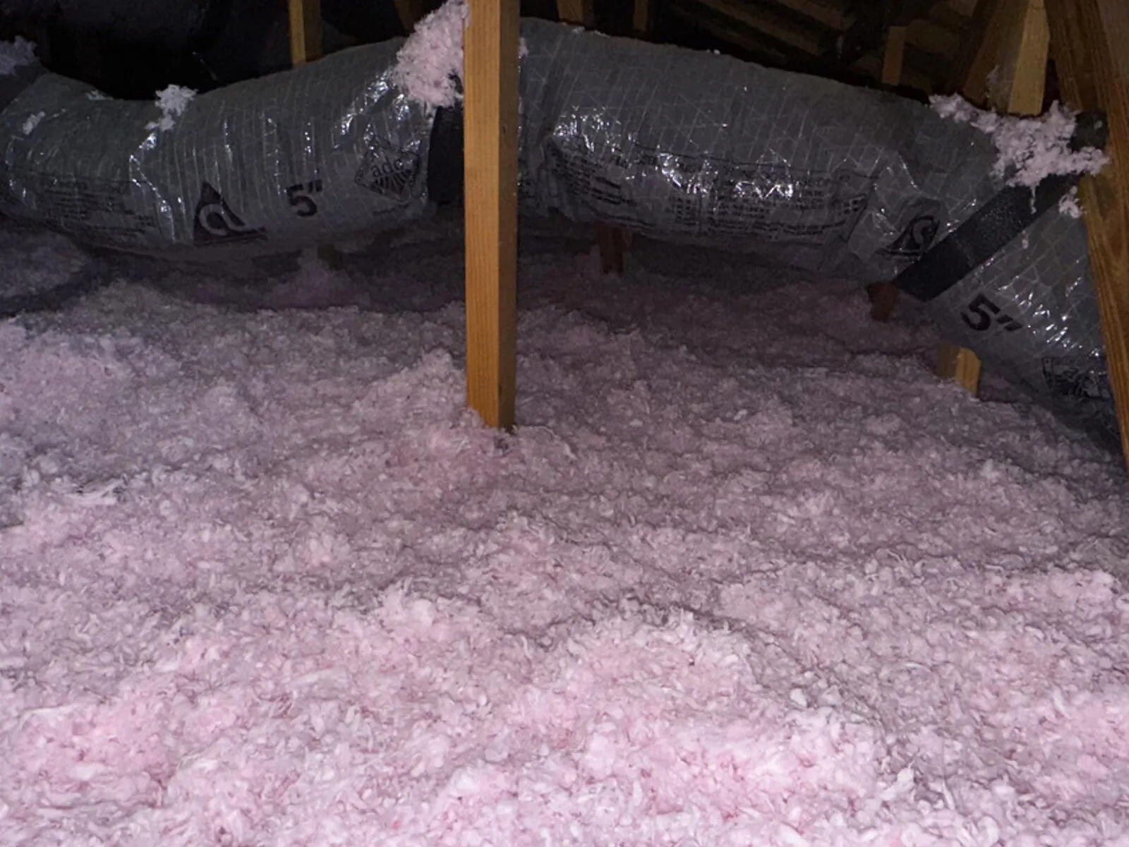 New blown-in fiberglass at full depth after removal and air sealing