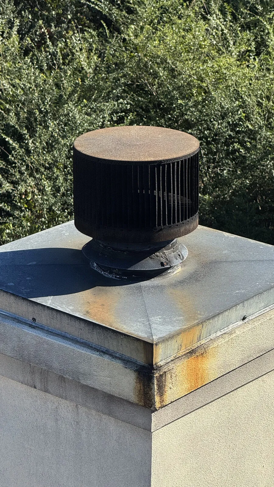 Rusted cap and chase cover, rust staining the crown below