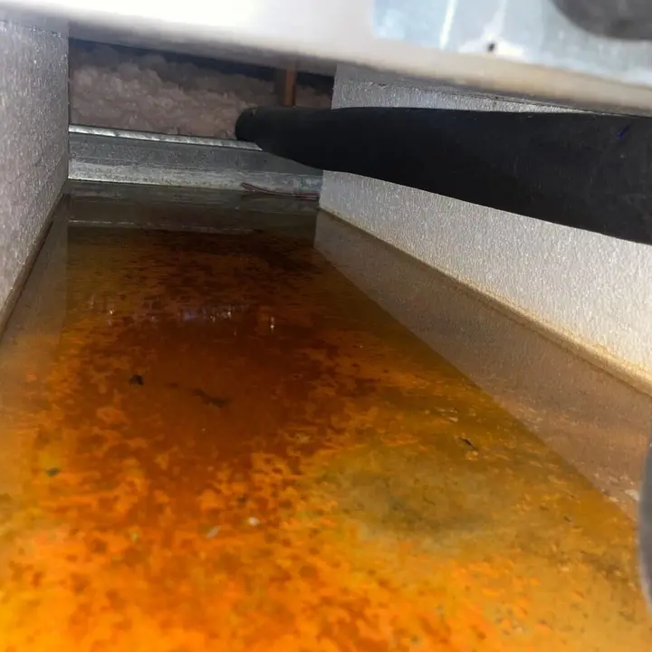 Drain pan with rusty water, Central Texas